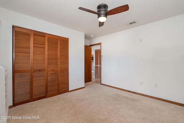 3021 Kirkland Rd NE, Palm Bay, FL 32905 - unfurnished bedroom featuring carpet floors, visible vents, a closet, baseboards, and ceiling fan