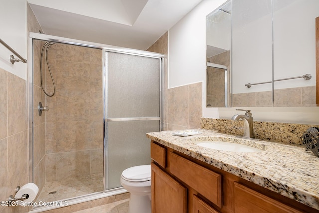 3021 Kirkland Rd NE, Palm Bay, FL 32905 - full bathroom with vanity, tile patterned flooring, toilet, tile walls, and a shower stall