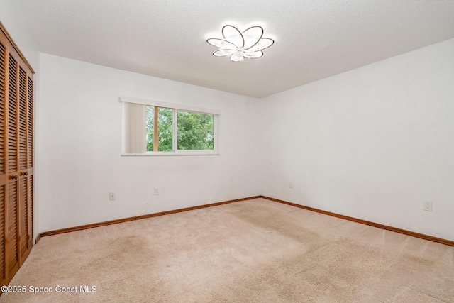 3021 Kirkland Rd NE, Palm Bay, FL 32905 - unfurnished bedroom with carpet floors, baseboards, and a closet