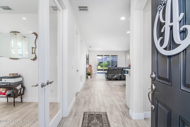 7921 Mocan Ct, Melbourne, FL 32940 - foyer entrance with light wood-type flooring, baseboards, recessed lighting, and french doors