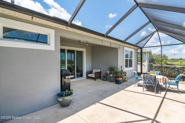 7921 Mocan Ct, Melbourne, FL 32940 - view of patio / terrace with outdoor dining space and glass enclosure