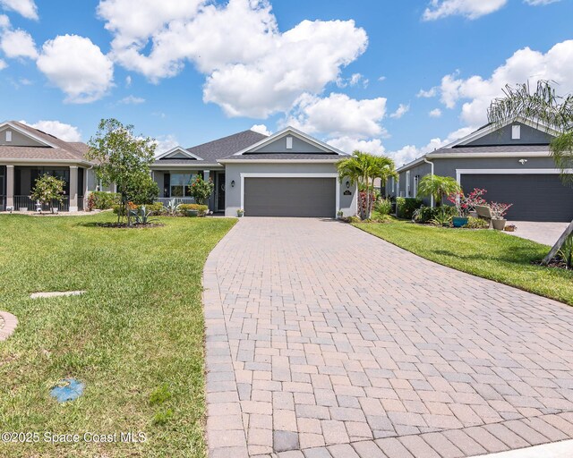7921 Mocan Ct, Melbourne, FL 32940 - ranch-style home with a garage, decorative driveway, a front yard, and stucco siding