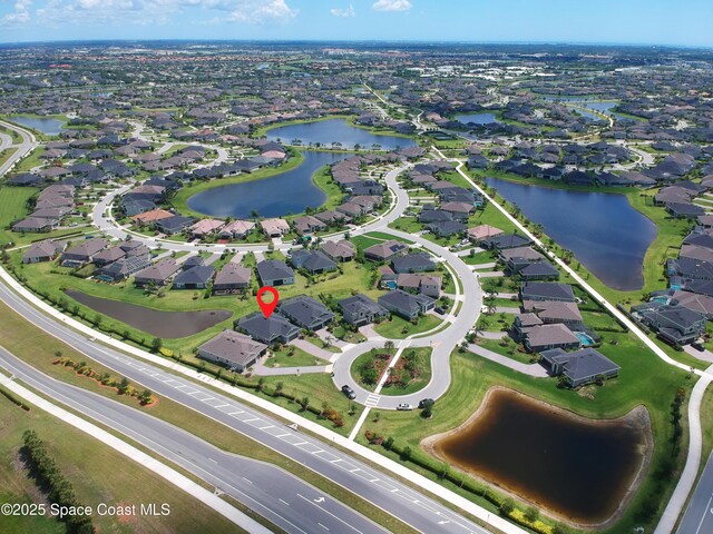 7921 Mocan Ct, Melbourne, FL 32940 - aerial view of property and surrounding area featuring nearby suburban area and a large body of water