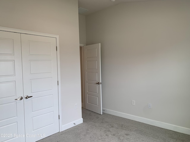 1005 Kylar Dr NW, Palm Bay, FL 32907 - unfurnished bedroom with baseboards, carpet, and a closet