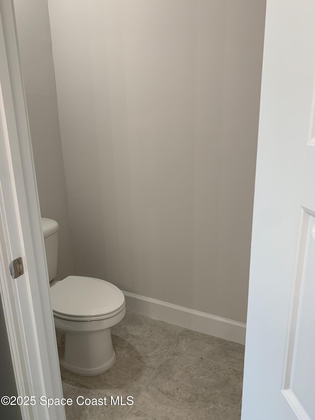 1005 Kylar Dr NW, Palm Bay, FL 32907 - bathroom featuring baseboards, tile patterned floors, and toilet