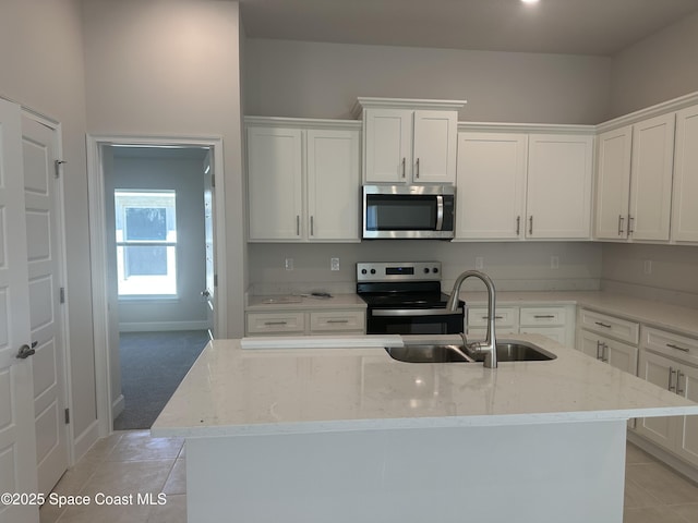 1128 Soleway Ave, Palm Bay, FL 32907 - kitchen with light stone counters, a sink, white cabinets, and stainless steel appliances