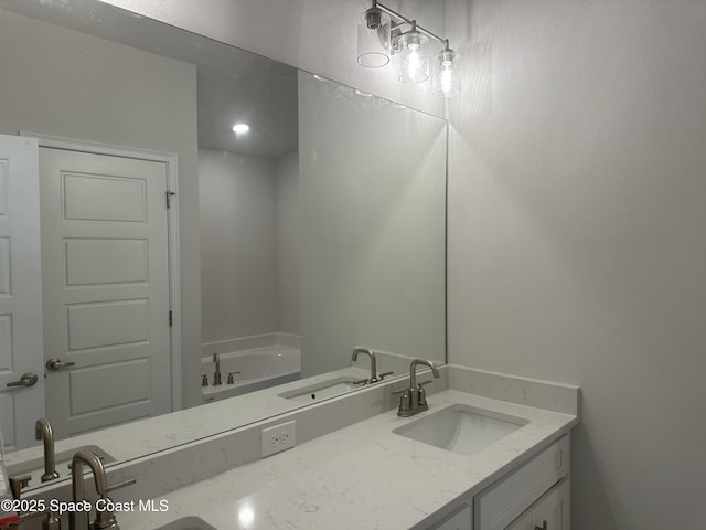1128 Soleway Ave, Palm Bay, FL 32907 - bathroom with double vanity, a bath, and a sink