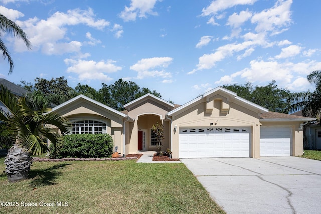 view of front of home featuring a garage, a front yard, concrete driveway, and stucco siding