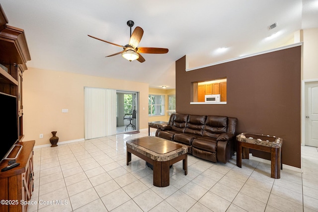 living room with vaulted ceiling, visible vents, a ceiling fan, light tile patterned floors, and baseboards