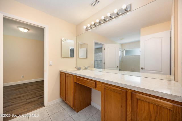 full bath with tile patterned floors, visible vents, baseboards, a shower stall, and vanity