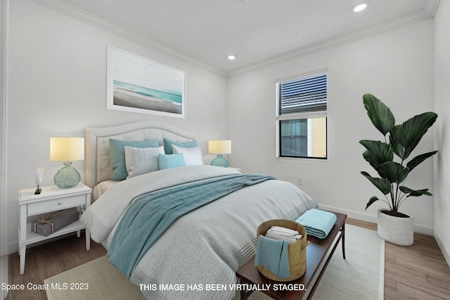bedroom featuring recessed lighting, wood finished floors, and crown molding