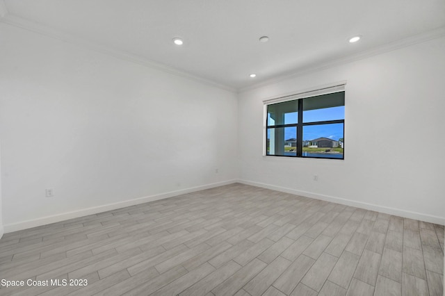 unfurnished room with baseboards, crown molding, and recessed lighting