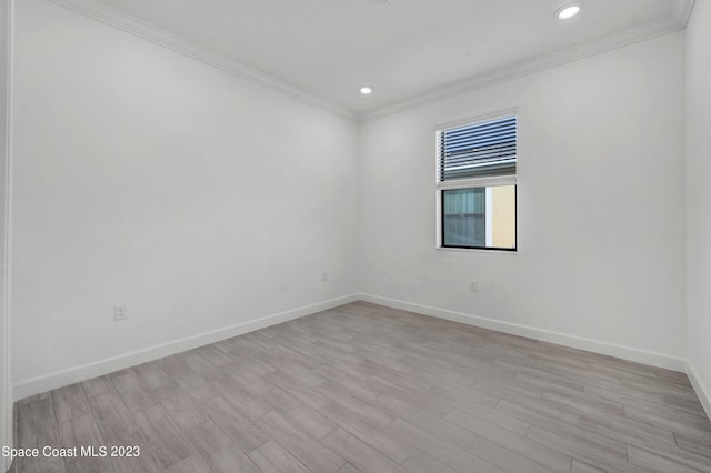 empty room with recessed lighting, light wood-style floors, crown molding, and baseboards