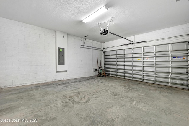 garage featuring electric panel, a garage door opener, and concrete block wall