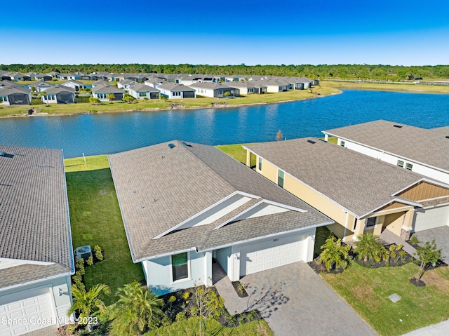 birds eye view of property with a water view and a residential view