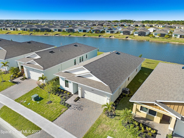 birds eye view of property with a residential view and a water view