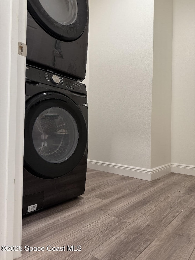 1430 Denali St SE, Palm Bay, FL 32909 - clothes washing area with stacked washer / dryer, wood finished floors, and baseboards