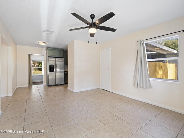 1640 Barna Ave, Titusville, FL 32780 - unfurnished living room with ceiling fan, baseboards, and light tile patterned floors