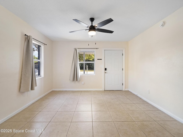 1640 Barna Ave, Titusville, FL 32780 - spare room with ceiling fan, baseboards, light tile patterned flooring, and plenty of natural light