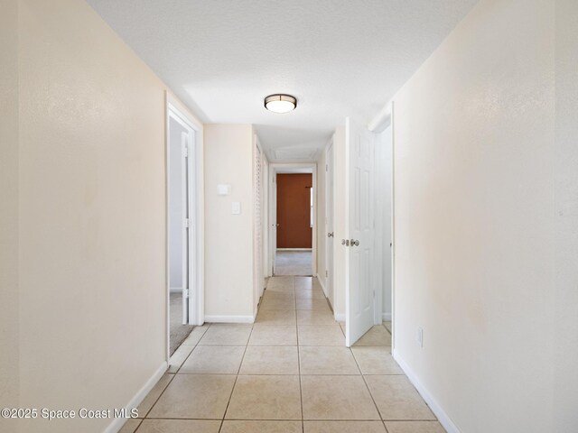 1640 Barna Ave, Titusville, FL 32780 - hall with baseboards and light tile patterned flooring
