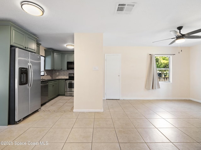 1640 Barna Ave, Titusville, FL 32780 - kitchen with backsplash, visible vents, light tile patterned floors, baseboards, and appliances with stainless steel finishes