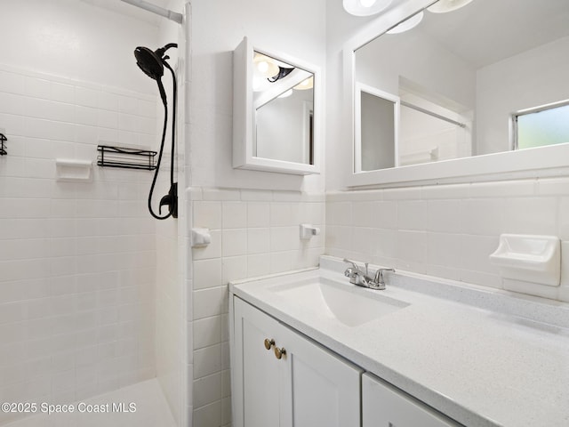 1640 Barna Ave, Titusville, FL 32780 - full bathroom with a tile shower, tile walls, and vanity
