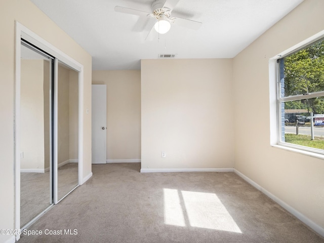 1640 Barna Ave, Titusville, FL 32780 - unfurnished bedroom with baseboards, a ceiling fan, carpet flooring, and visible vents