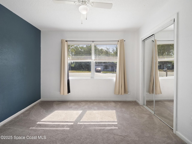 1640 Barna Ave, Titusville, FL 32780 - unfurnished bedroom featuring a closet, carpet flooring, baseboards, and ceiling fan