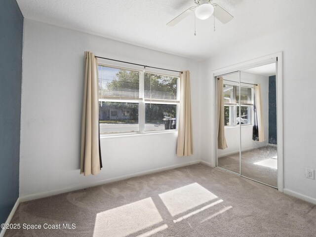 1640 Barna Ave, Titusville, FL 32780 - unfurnished bedroom with a closet, multiple windows, and carpet