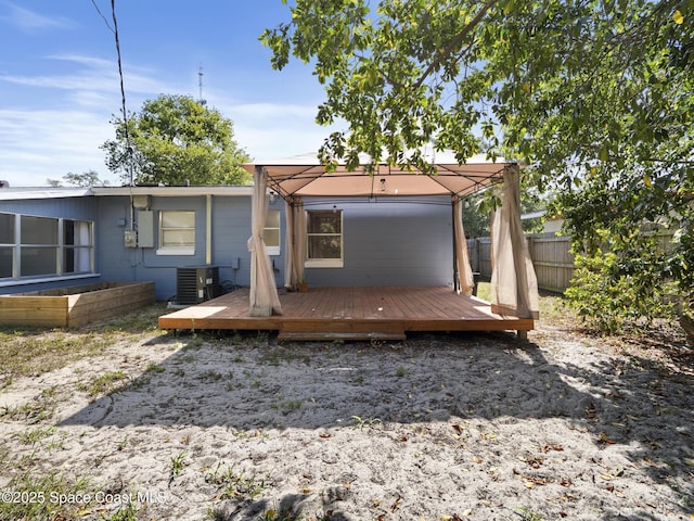 1640 Barna Ave, Titusville, FL 32780 - back of property with fence, central AC, and a deck