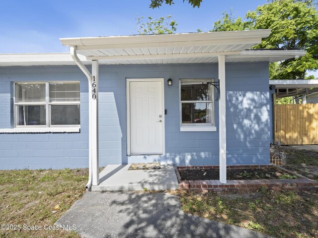 1640 Barna Ave, Titusville, FL 32780 - doorway to property with fence and concrete block siding