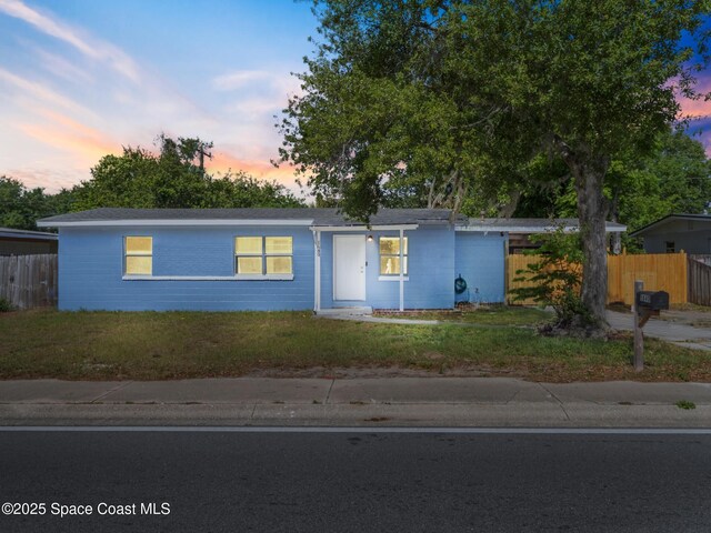1640 Barna Ave, Titusville, FL 32780 - ranch-style house with a lawn and fence