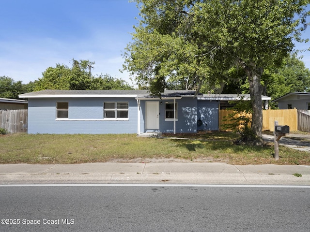 1640 Barna Ave, Titusville, FL 32780 - ranch-style home featuring a front yard and fence