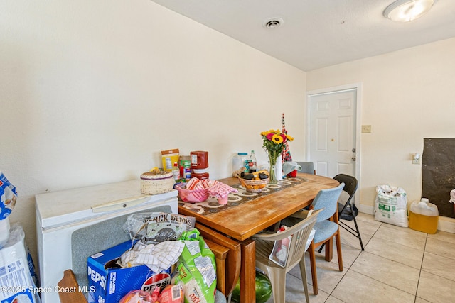 dining area featuring light tile patterned floors and visible vents