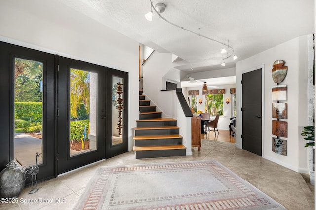 450 Ross Ave, Melbourne Beach, FL 32951 - tiled foyer entrance featuring plenty of natural light, stairs, and french doors