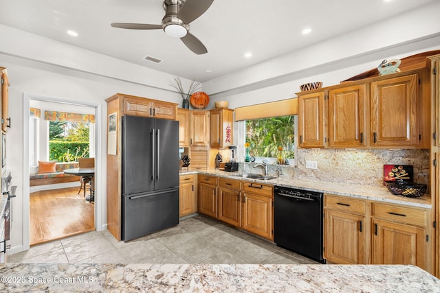 450 Ross Ave, Melbourne Beach, FL 32951 - kitchen with visible vents, black dishwasher, high quality fridge, recessed lighting, and light stone counters