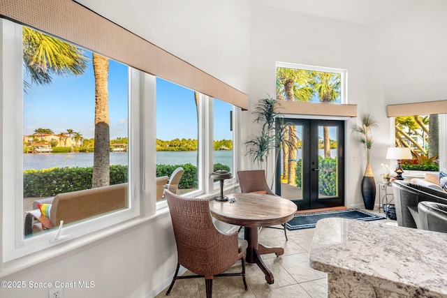 450 Ross Ave, Melbourne Beach, FL 32951 - sunroom / solarium with french doors, a wealth of natural light, and a water view