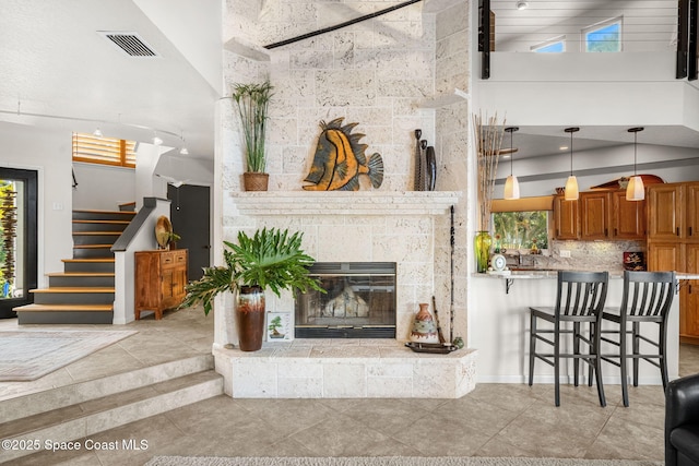 450 Ross Ave, Melbourne Beach, FL 32951 - living area featuring stairs, light tile patterned floors, visible vents, and a healthy amount of sunlight