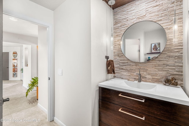 450 Ross Ave, Melbourne Beach, FL 32951 - bathroom featuring vanity, baseboards, and tile patterned flooring