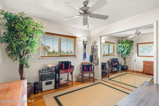 450 Ross Ave, Melbourne Beach, FL 32951 - sitting room featuring ceiling fan, baseboards, wood finished floors, and a textured ceiling