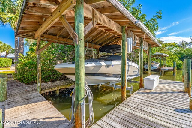 450 Ross Ave, Melbourne Beach, FL 32951 - view of dock featuring boat lift
