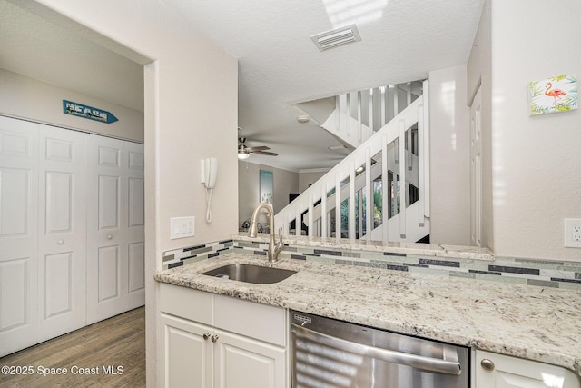 326 Seaport Blvd Unit T95, Cape Canaveral, FL 32920 - kitchen featuring stainless steel dishwasher, a sink, wood finished floors, a ceiling fan, and light stone countertops