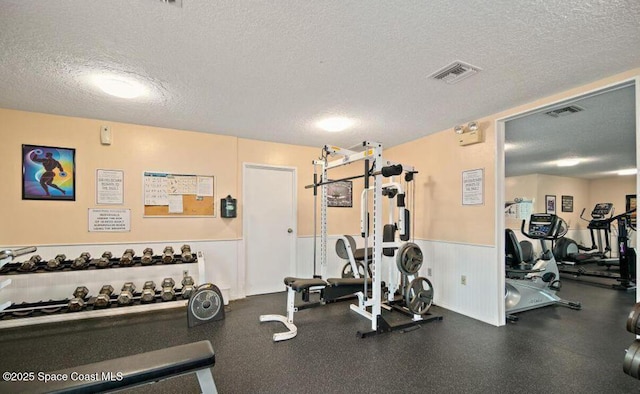 326 Seaport Blvd Unit T95, Cape Canaveral, FL 32920 - workout area with a textured ceiling and a wainscoted wall