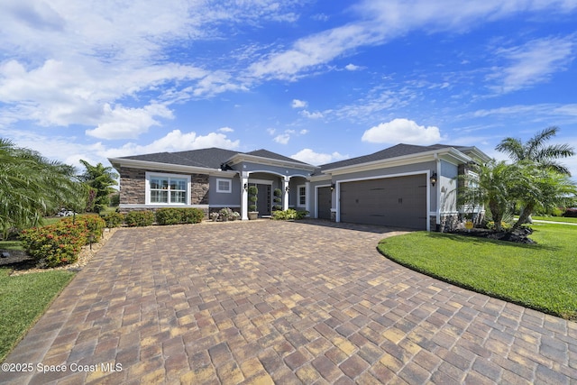 view of front of home featuring a front lawn, driveway, stone siding, an attached garage, and stucco siding