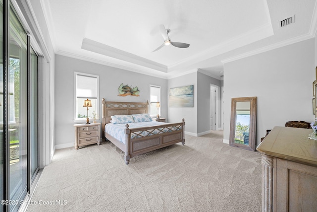 bedroom with light carpet, visible vents, a raised ceiling, and multiple windows