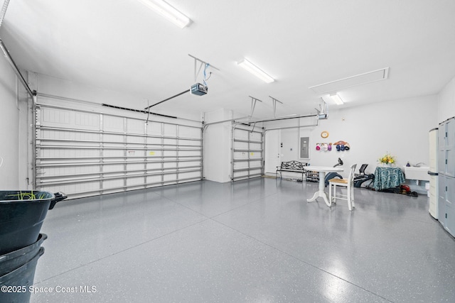 garage featuring electric panel and a garage door opener