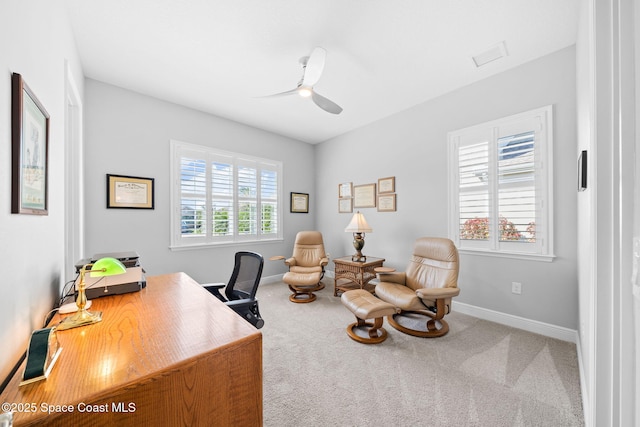 office featuring a ceiling fan, baseboards, and carpet