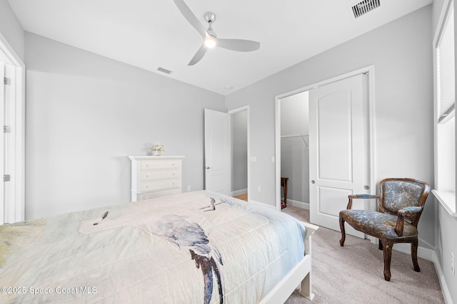 bedroom featuring a closet, baseboards, visible vents, and light colored carpet