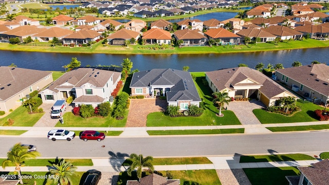 bird's eye view featuring a residential view and a water view