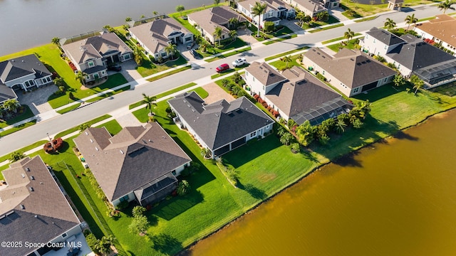 birds eye view of property featuring a residential view and a water view